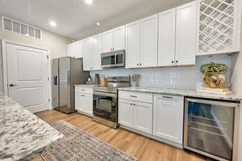 A kitchen with white cabinets